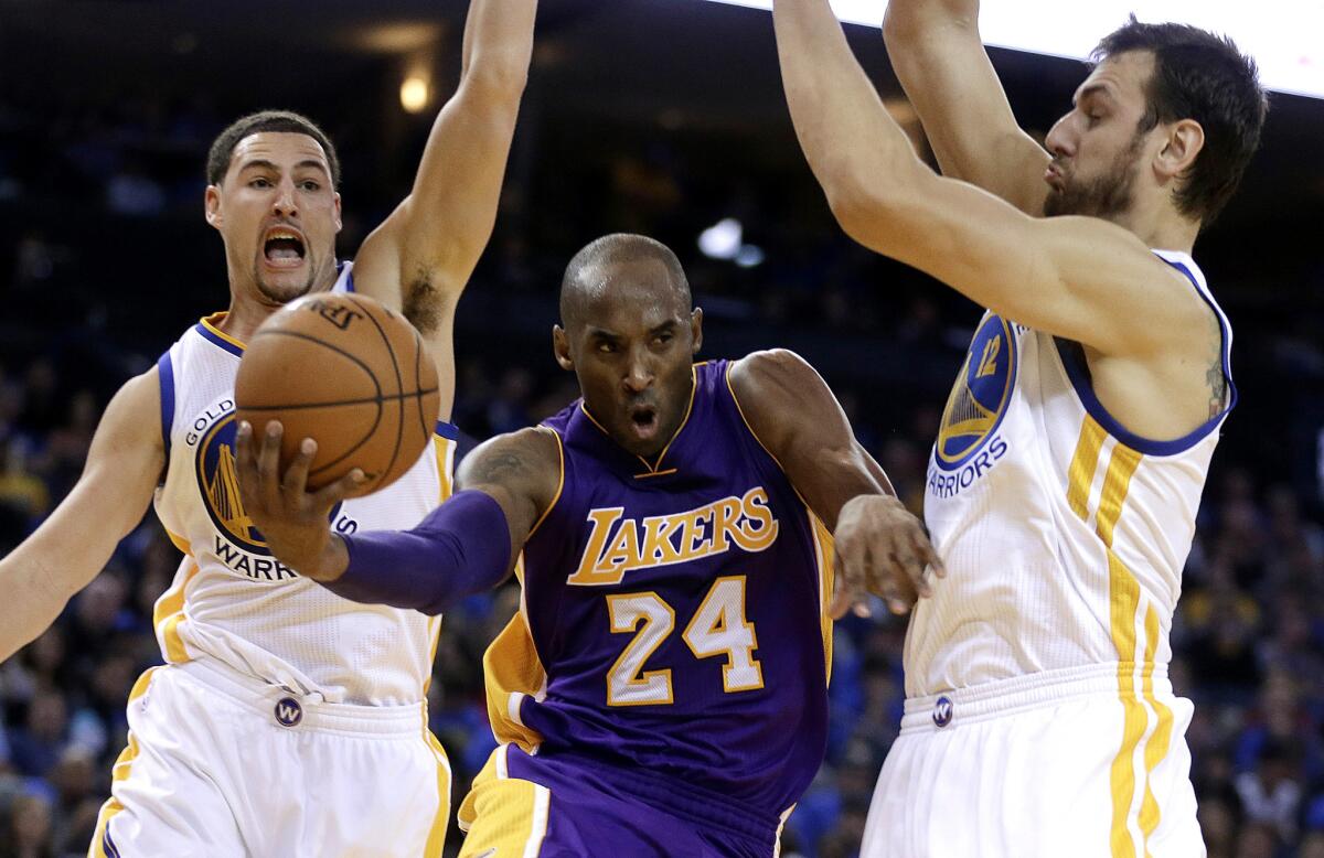 Kobe Bryant, shown driving between Golden State's Klay Thompson and Andrew Bogut, scored 28 points in the Nov. 1 game, but the Lakers still lost, 127-104, in Oakland.