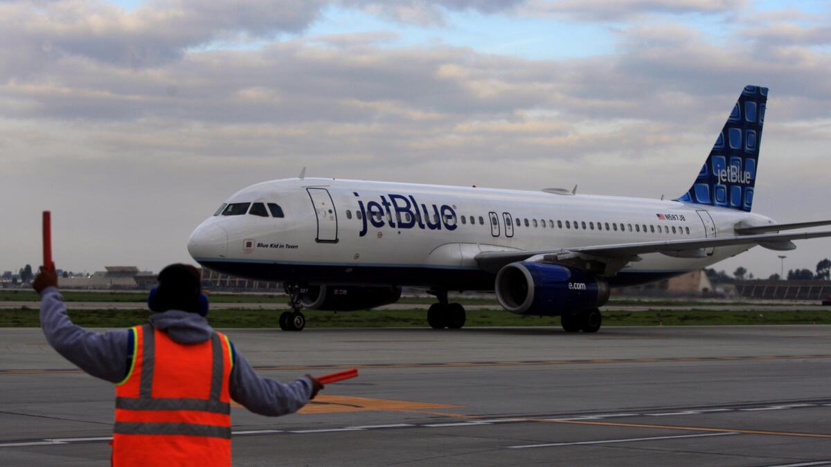 A Jet Blue flight taxis at the Long Beach Airport in 2012. The airline has asked the city of Long Beach to look into allowing international flights.