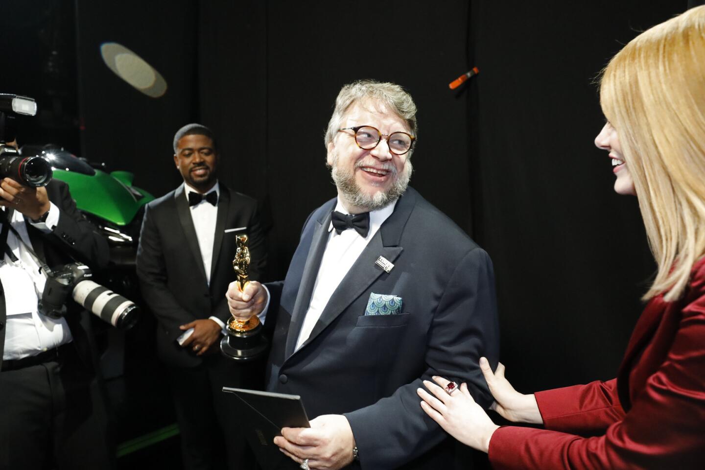 Guillermo del Toro after winning for best director and presenter Emma Stone backstage at the 90th Academy Awards on Sunday at the Dolby Theatre in Hollywood.