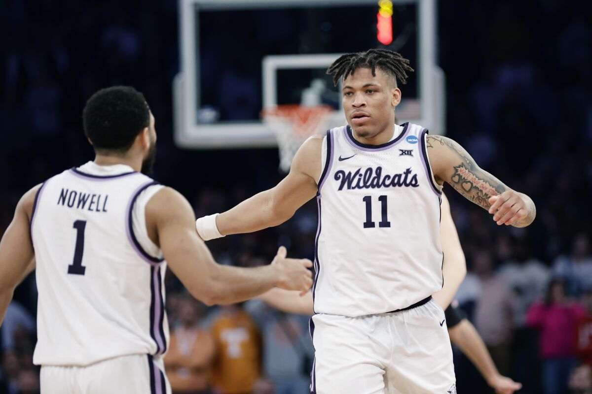 Kansas State forward Keyontae Johnson (11) is greeted by guard Markquis Nowell (1) after a play in overtime of a Sweet 16 college basketball game against Michigan State in the East Regional of the NCAA tournament at Madison Square Garden, Thursday, March 23, 2023, in New York. (AP Photo/Adam Hunger)