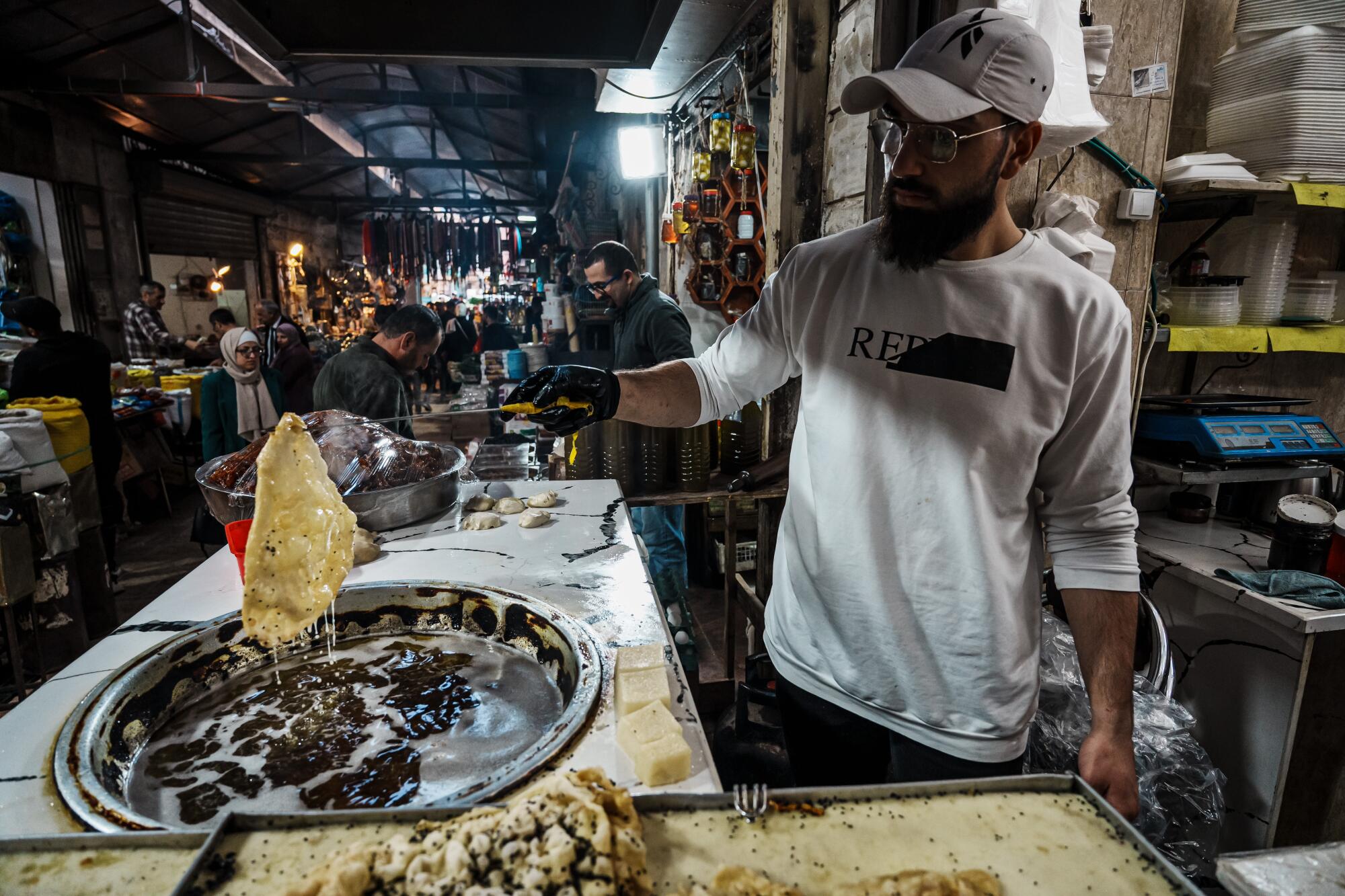 Man cooking dough for a dessert in Nablus, West Bank
