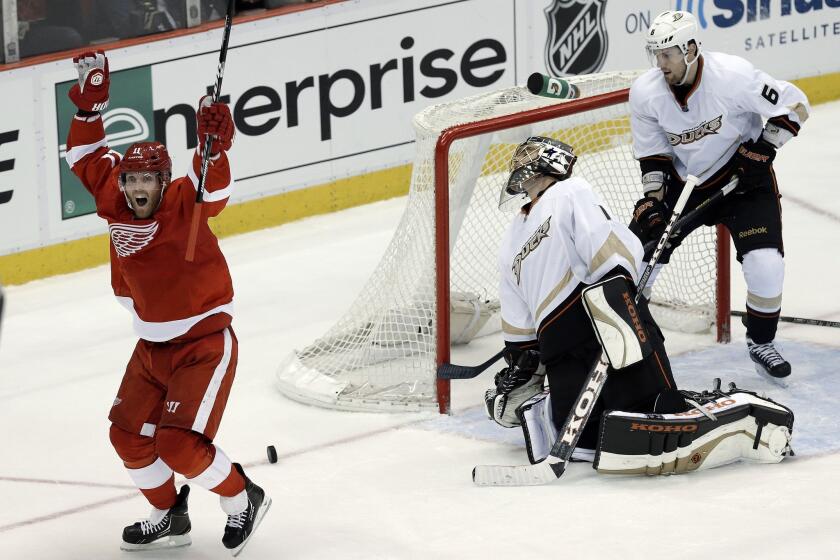 Detroit's Daniel Cleary, left, celebrates after scoring a goal past Ducks goalie Jonas Hiller as defenseman Ben Lovejoy looks on during Game 6 of the Western Conference quarterfinals in May. The Ducks will play the Red Wings on Tuesday for the first time since last season's playoff-series loss to Detroit.