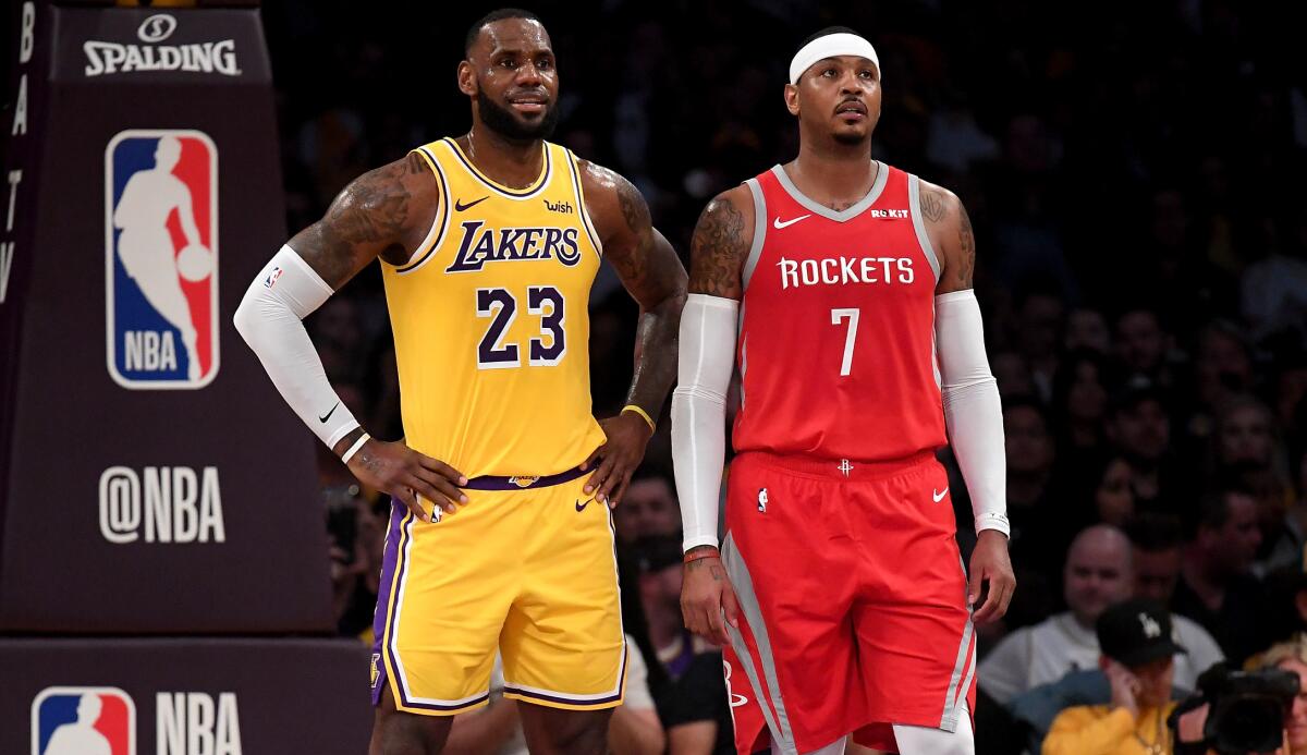 Lakers forward LeBron James and Rockets forward Carmelo Anthony chat during a break in play on Oct. 20, 2018, at Staples Center.