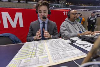 Carlo Jimenez, 22, the new radio play-by-play voice of the LA Clippers with his player boards for the Clippers and 76ers during the pregame show at the Crypto.com arena in Los Angeles, Calif. He is the only Hispanic radio play-by-play voice on American broadcasts in the NBA. At right is radio broadcast engineer Jake Warner.