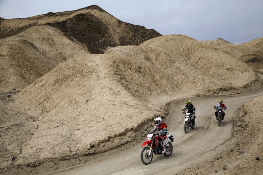 A trio rides through Twenty Mule Team Canyon, a one-way 2.7-mile unpaved loop located in the Furnace Creek area of Death Valley.