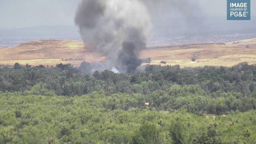 In this screen shot from a PG&E web camera, a vegetation fire ignited in Butte County burns on Tuesday.