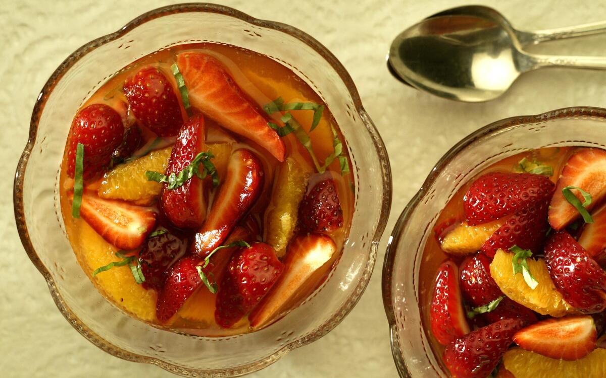 Strawberries and oranges in basil syrup