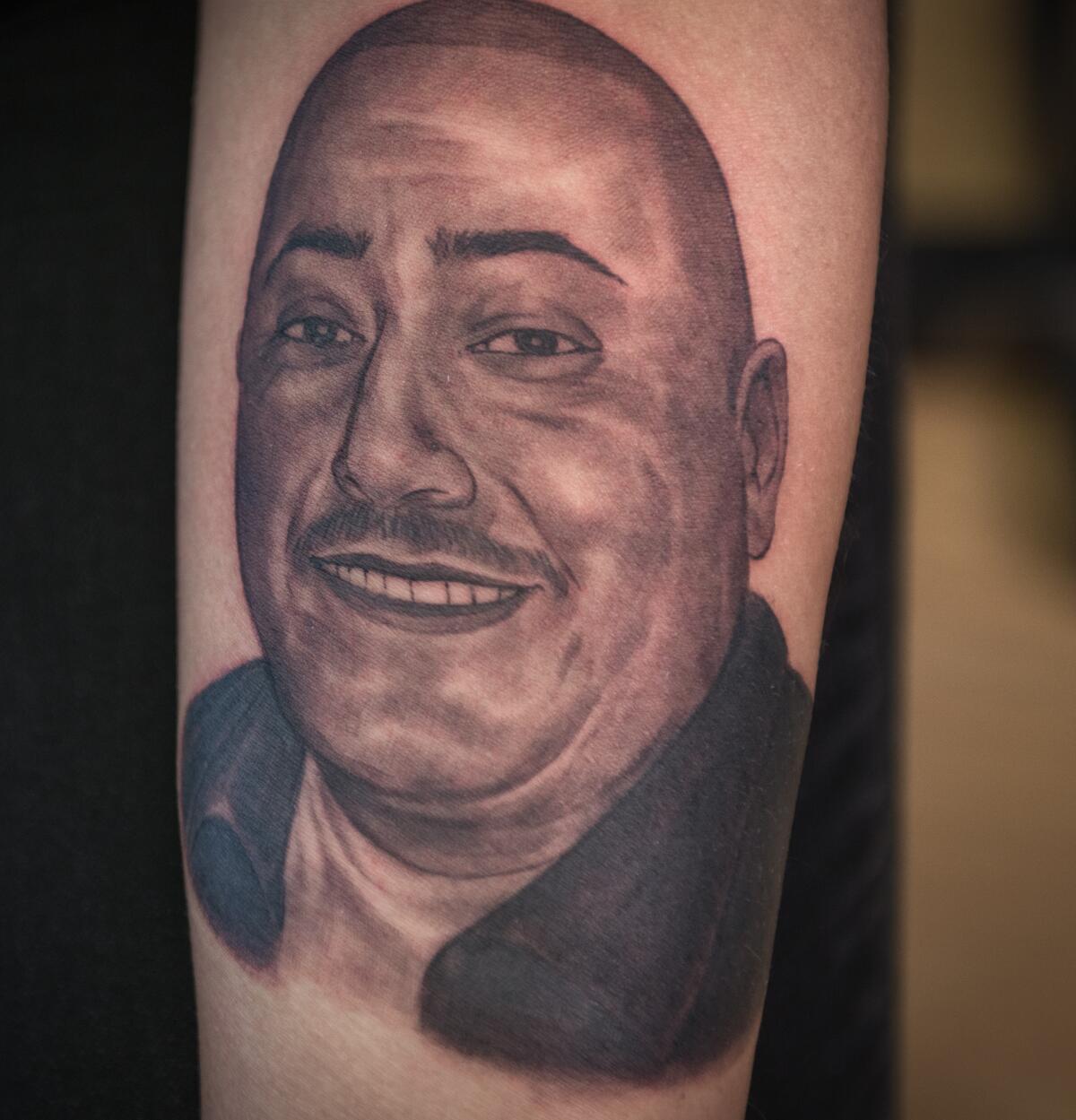 Tattooed portrait of Philip Martin Martinez on Anita’s arm. 