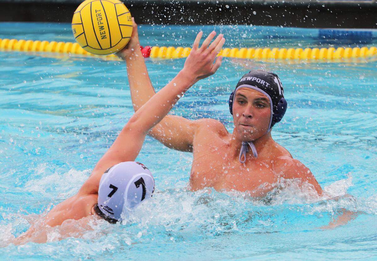 Newport Harbor's Geoff Slutzky (15) passes over Harvard-Westlake's Jack Shapiro (7).