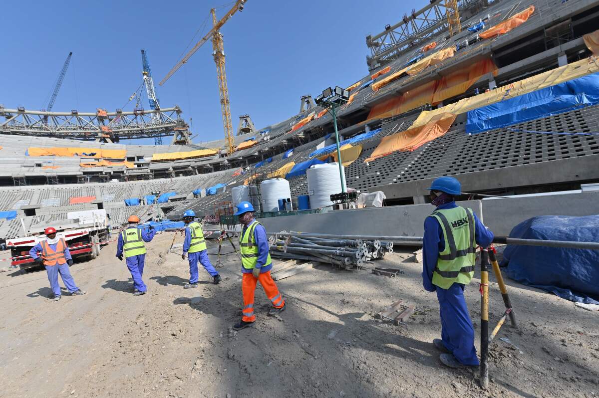 A picture taken on December 20, 2019 shows construction workers at Qatar's Lusail Stadium, around 20 kilometres north of the capital Doha. (Photo by GIUSEPPE CACACE / AFP) (Photo by GIUSEPPE CACACE/AFP via Getty Images)