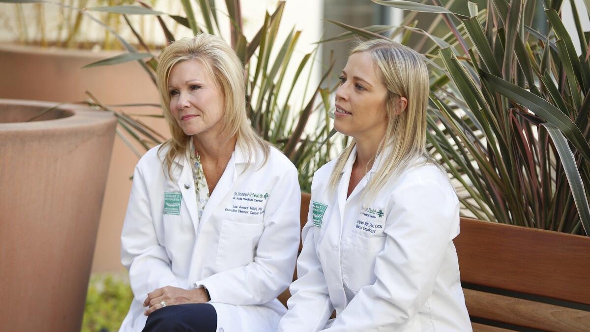 Lea Ament, left, and Tamara Nunley talk about the care their team provided for Helen and Robert Valenzuela at St. Jude Medical Center in Fullerton.