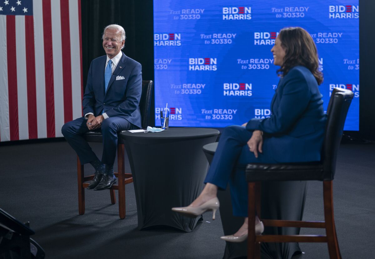 FILE - In this Aug. 12, 2020, file photo Democratic presidential candidate former Vice President Joe Biden and his running mate Sen. Kamala Harris, D-Calif., participate in a virtual grassroots fundraiser at the Hotel DuPont in Wilmington, Del. The Democratic Party will convene Monday, Aug. 17, sort of, amid a pandemic that has upended the usual pomp-and-circumstance of presidential nominating conventions. (AP Photo/Carolyn Kaster, File)