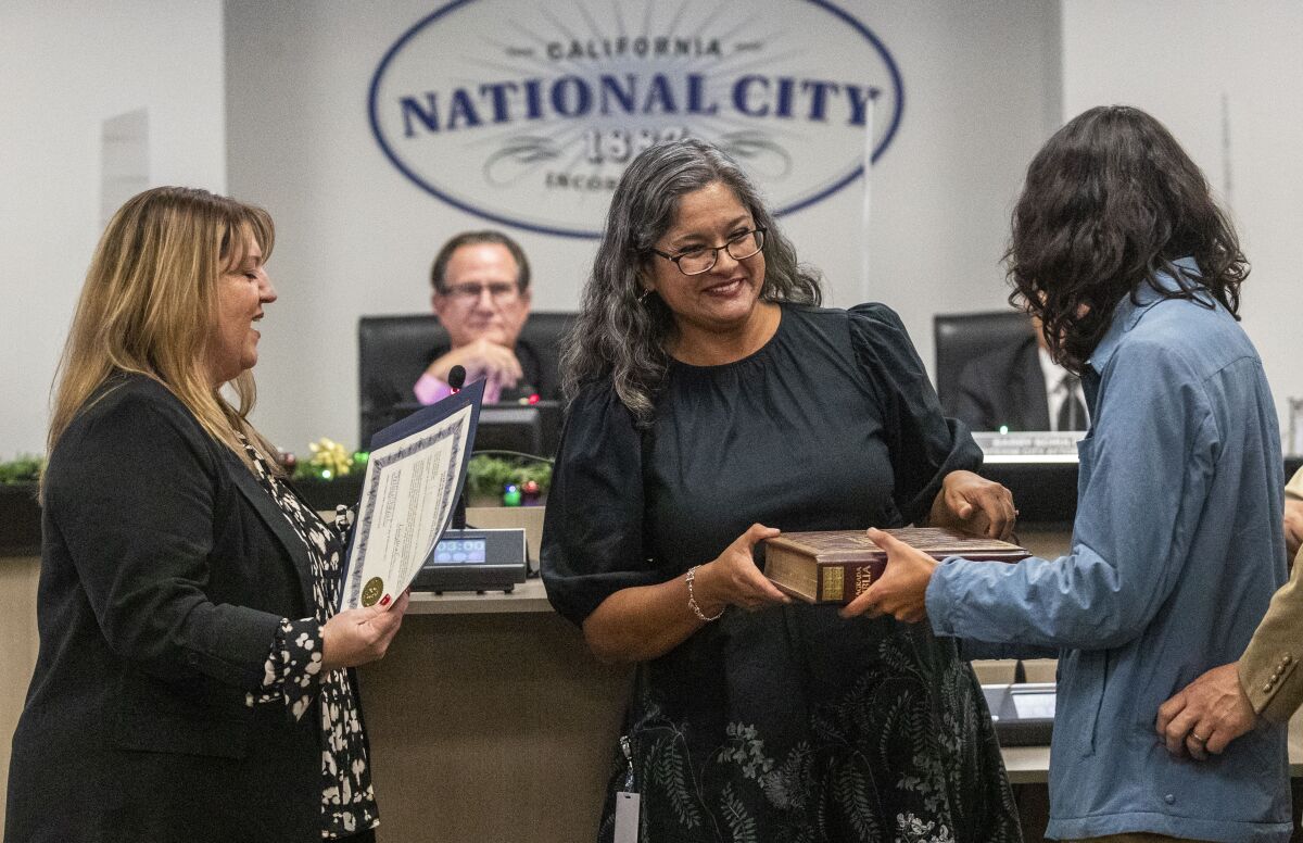 National City, CA - December 13: National City council member Luz Molina, District 1, center, is sworn in.