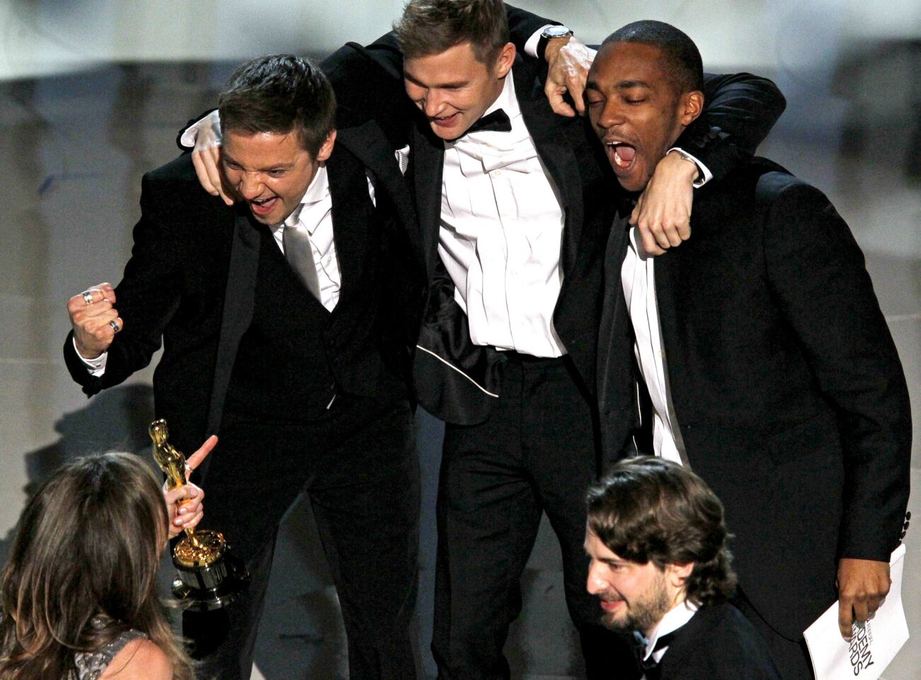 Jeremy Renner, from left, Brian Geraghty and Anthony Mackie of "The Hurt Locker" rejoice after the film in which they co-starred won best picture at the 82nd Academy Awards. Screenwriter Mark Boal is at lower right.