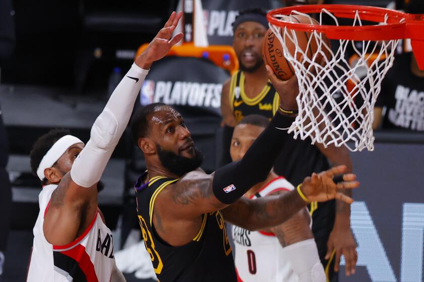 Los Angeles Lakers' LeBron James (23) shoots against Portland Trail Blazers' Carmelo Anthony.