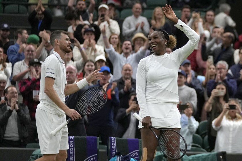 Venus Williams of the U.S. and Britain's Jamie Murray celebrate winning a mixed doubles match against Poland's Alicja Rosolska and New Zealand's Michael Venus on day five of the Wimbledon tennis championships in London, Friday, July 1, 2022. (AP Photo/Alastair Grant)
