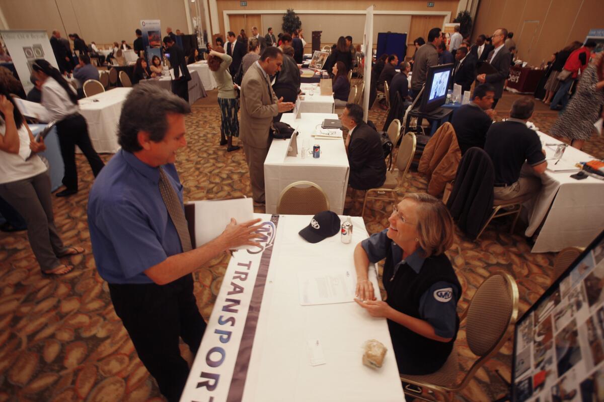 Nearly half of California residents are struggling financially, according to a new report. Pictured, a job fair at the Hyatt Regency in Irvine last March.
