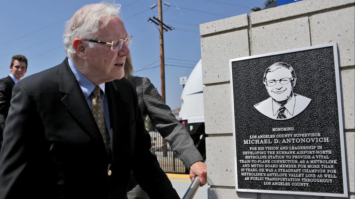 Former Los Angeles County Supervisor Michael Antonovich looks over a plaque placed in his name at the newly constructed Burbank Airport North Metrolink Station, during dedication ceremony on Thursday, May 10, 2018.