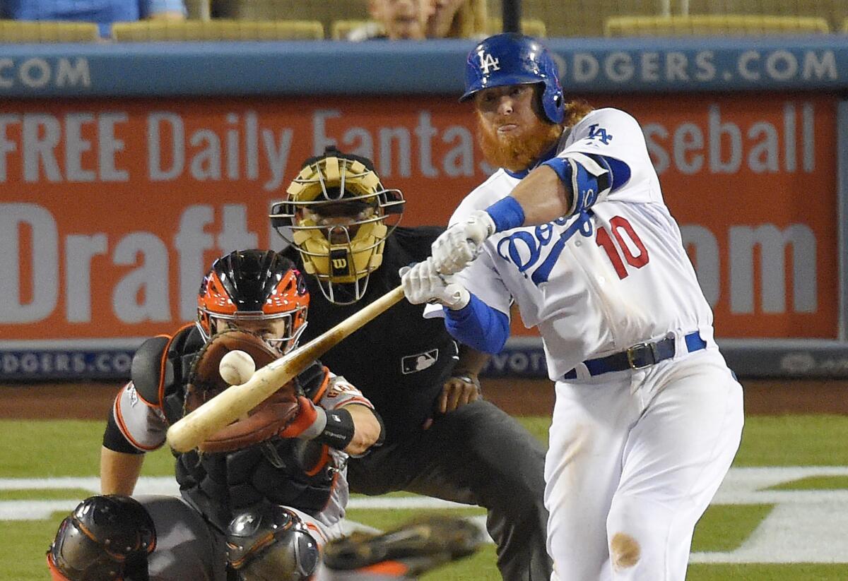 Dodgers third baseman Justin Turner hits a solo home run in the bottom of the ninth inning against the San Francisco Giants. The Dodgers lost to the Giants, 9-5.
