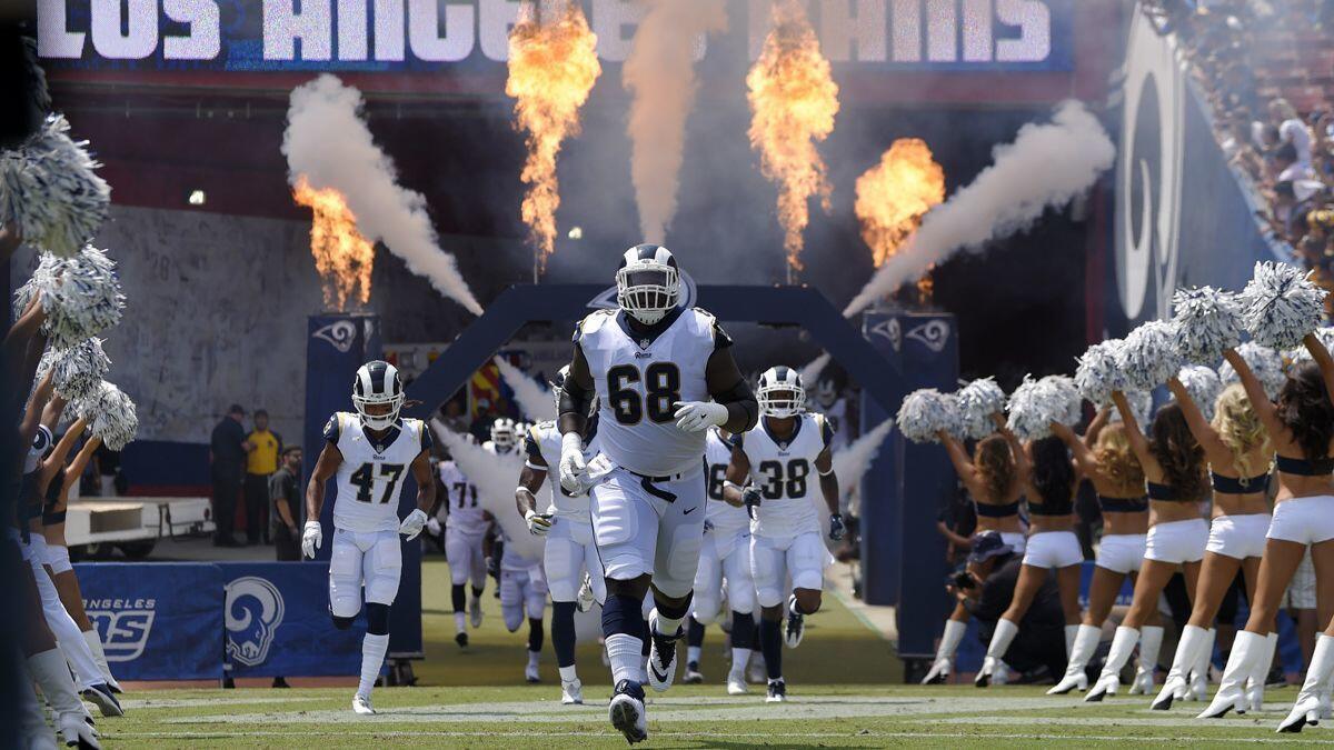 The Rams including offensive guard Jamon Brown, center, take the field prior to a preseaspm game against the Houston Texans on Aug. 25.