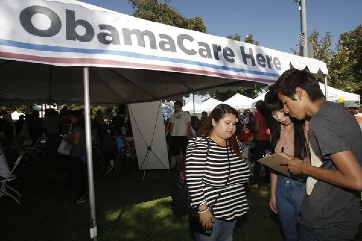 At the South L.A. Power Festival on Saturday, Gabriela Serrato, left, participates in a survey on better health with Dulce Rosas, 17, and Eric Bartolo, 17. Rosas and Bartolo are students at Fremont High School. Serrato, 29, came to the festival to find out more about Obamacare and to get involved in community organizations.