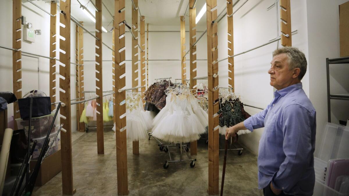 Marat Daukayev stands in the nearly empty wardrobe room at his ballet school. The rest of the costumes have been taken to storage.