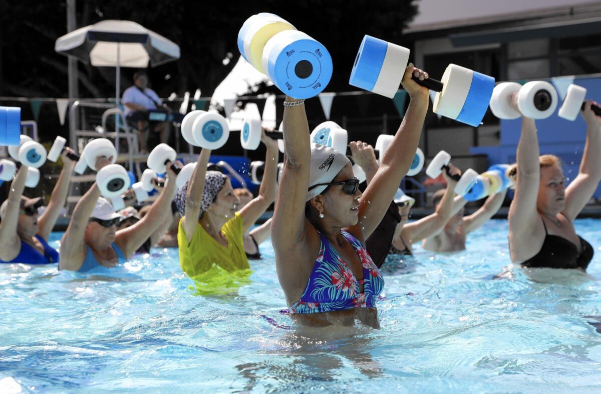 Maria Terrones, center foreground, participates in a water fitness class at the West Hollywood Pool.