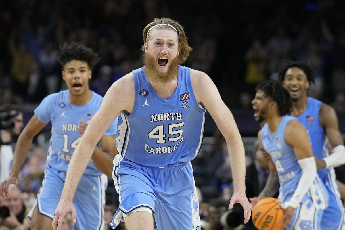 North Carolina's Brady Manek (45) celebrates after beating Duke in a college basketball game during the semifinal round of the Men's Final Four NCAA tournament, Saturday, April 2, 2022, in New Orleans. (AP Photo/David J. Phillip)