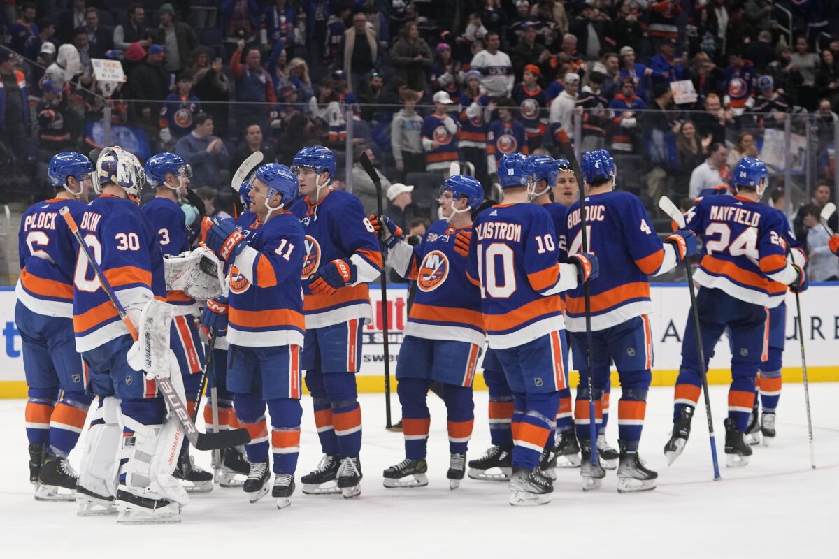New York Islanders' Zach Parise (11) and goaltender Ilya Sorokin (30) celebrate with teammates after an NHL hockey game against the Seattle Kraken Tuesday, Feb. 7, 2023, in Elmont, N.Y. The Islanders won 4-0. (AP Photo/Frank Franklin II)