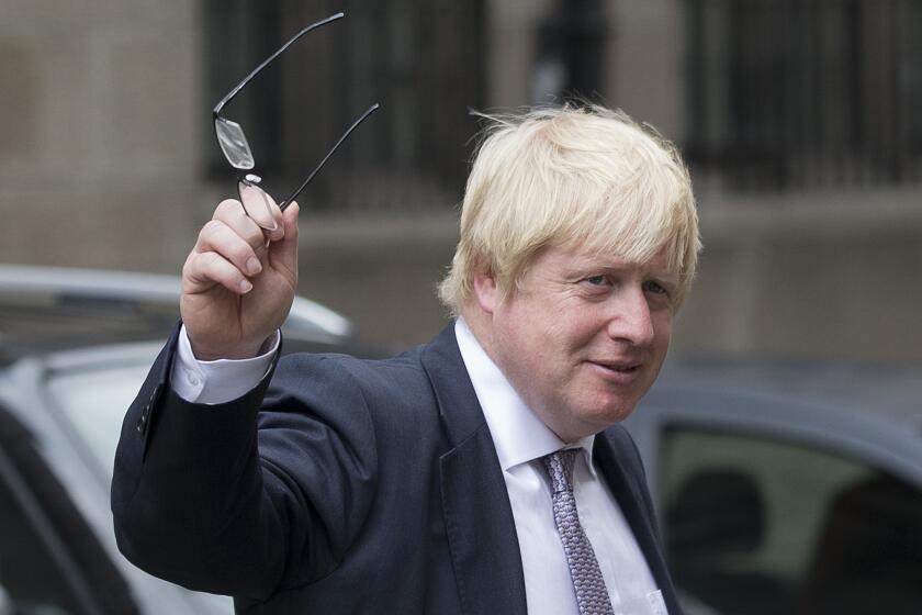 Former London mayor and Brexit campaigner Boris Johnson walks outside Parliament in central London on Monday.