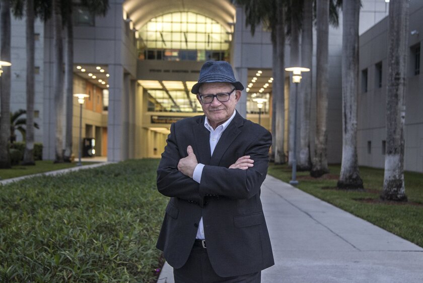 Mark B. Rosenberg, poses for a photo at the Florida International University campus, Miami, Dec. 14, 2021. Last week Rosenberg abruptly resigned as president of the university. At first he cited health problems. A follow-up statement Sunday blames his wife's advanced dementia in part for him getting emotionally entangled with a co-worker. The Miami Herald reports that a woman in her 20s said the 72-year-old academic had been harassing her for months and wouldn't stop. That prompted an investigation, and the Board of Trustees told him to resign or be fired. (Pedro Portal /Miami Herald via AP)