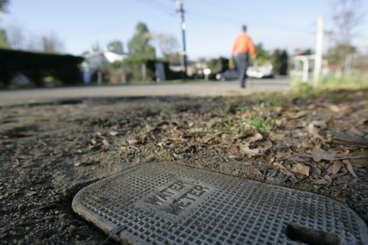 A meter maintenance worker reads meters in Lakeside in 2011.