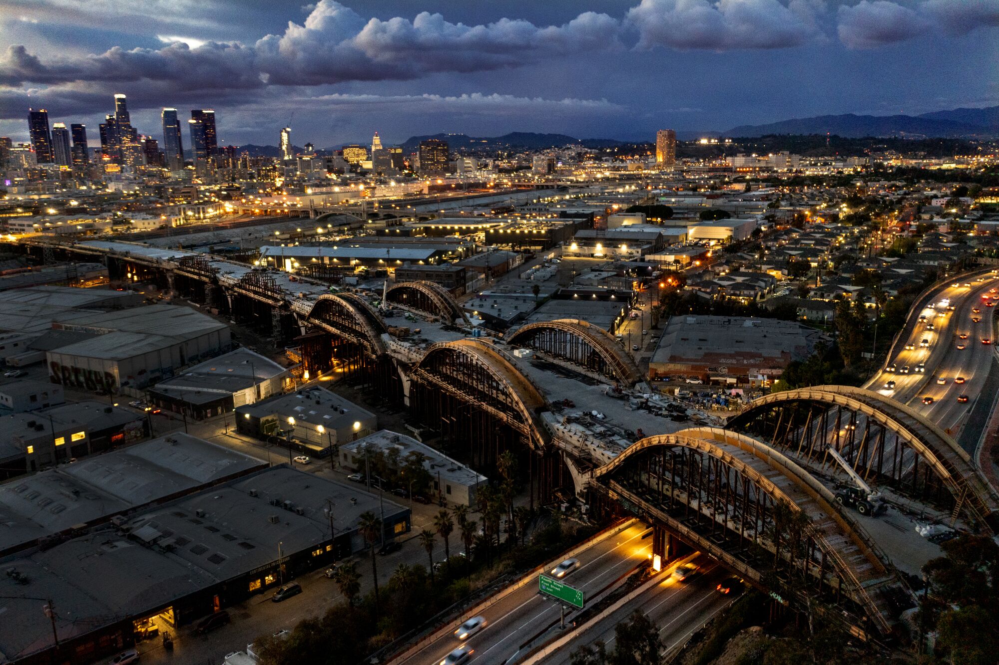March 11: Work continues on the 6th Street Viaduct against a backdrop of the downtown L.A. skyline after sunset.