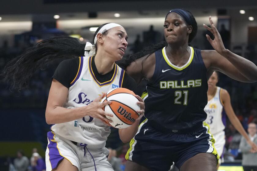 Los Angeles Sparks forward Dearica Hamby (5) drives against Dallas Wings center Kalani Brown (21) during the second half of a WNBA basketball basketball game in Arlington, Texas, Wednesday, June 14, 2023. (AP Photo/LM Otero)