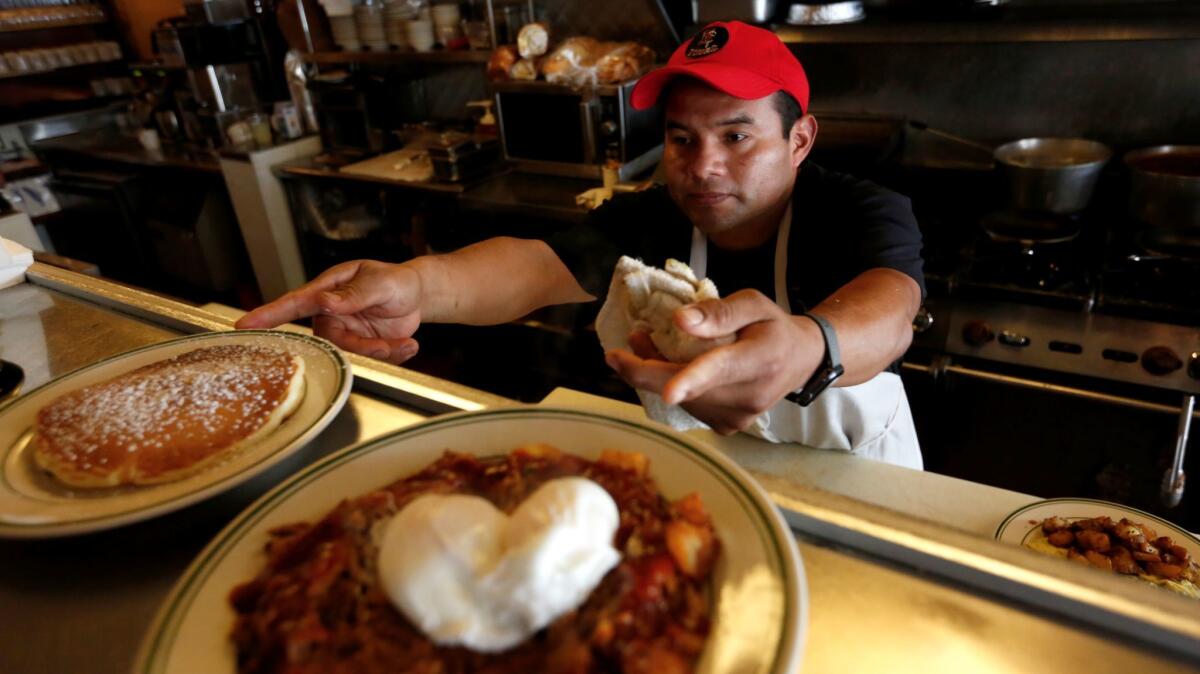Jesus Matias prepares dishes at the Nickel Diner in Los Angeles. California's leisure and hospitality sector saw an increase in jobs in July.