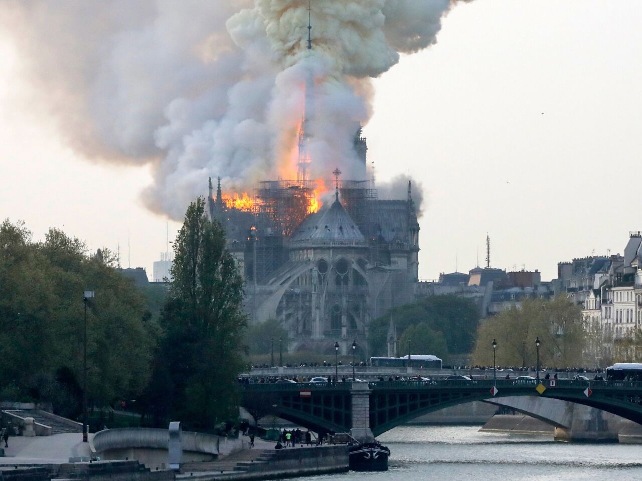 Smokes ascends as flames rise during the fire at the landmark Notre Dame Cathedral.