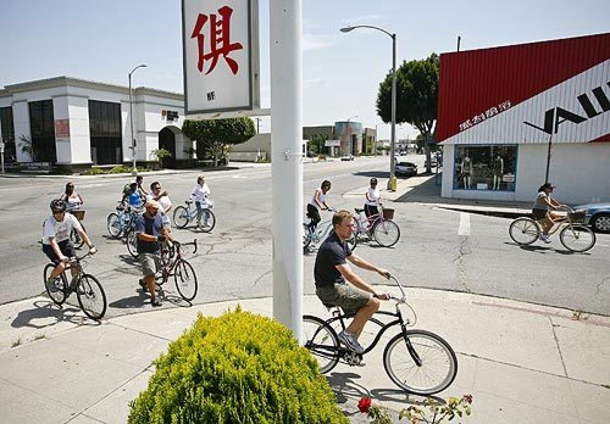 Bicyclists cruise the streets during a ride to a dim sum restaurant in Alhambra. Flying Pigeon LA bike shop, owned by brothers Adam and Josef Bray-Ali, sponsors the once-a-month ride to different restaurants.