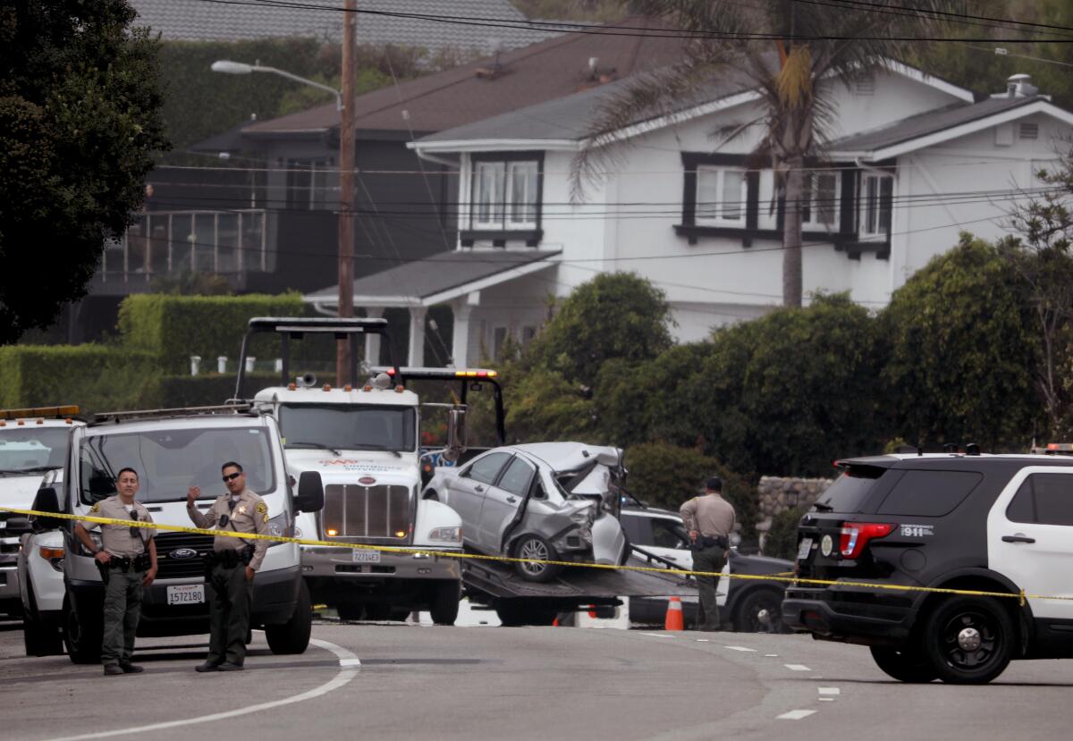 Crime scene tape stretches across the road in the aftermath of a collision that killed four people in Malibu on Oct. 17.