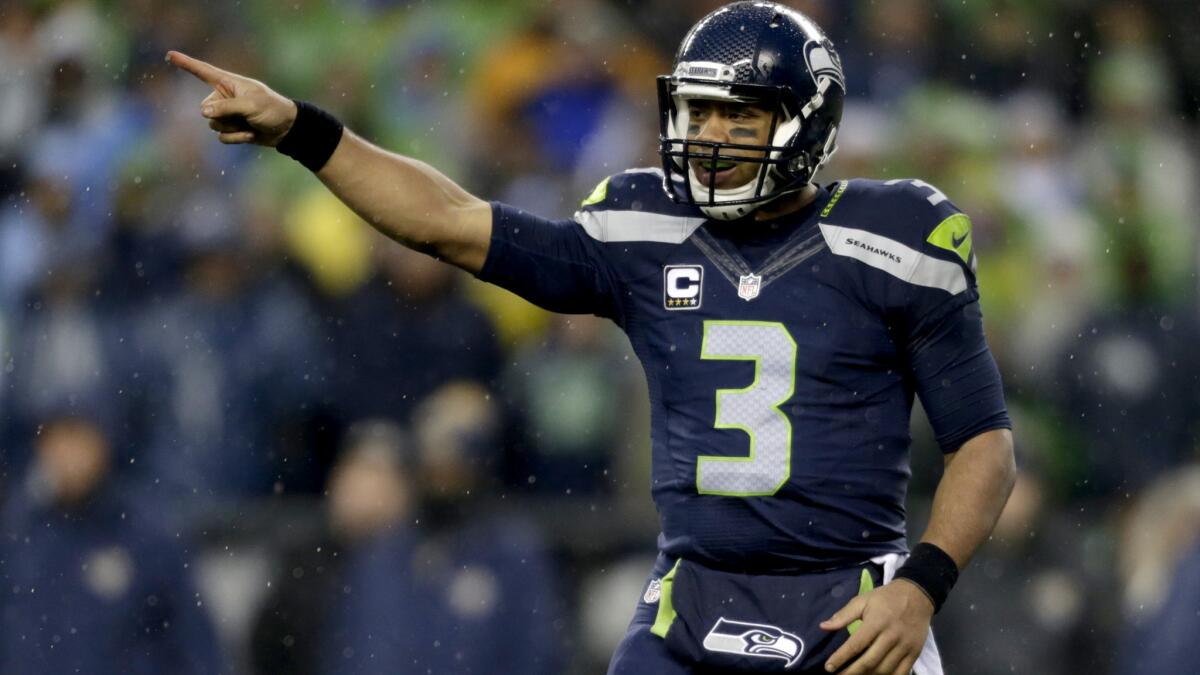 Seahawks quarterback Russell Wilson might be doing more handing off and running himself than passing against the Vikings during Sunday's frigid playoff game in Minnesota.