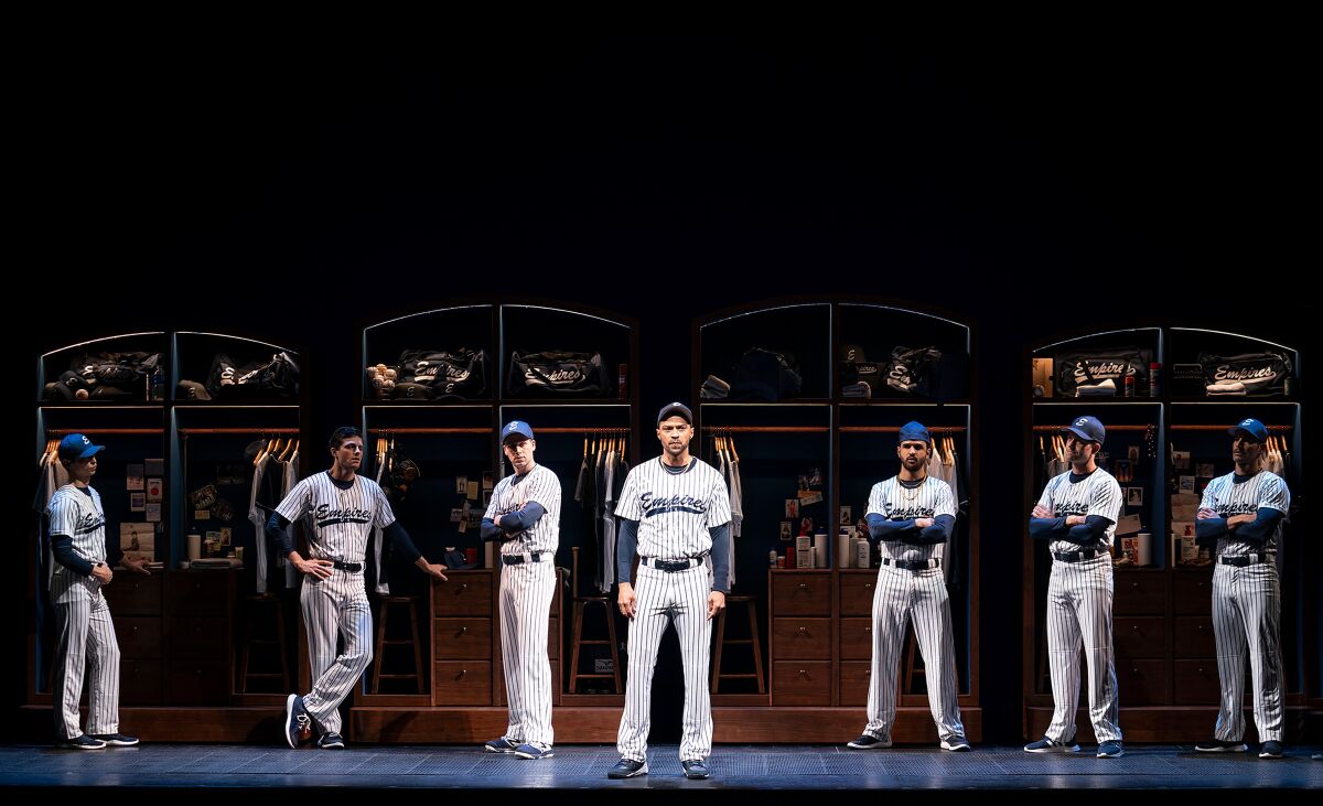 Seven men in baseball uniforms in a line onstage.