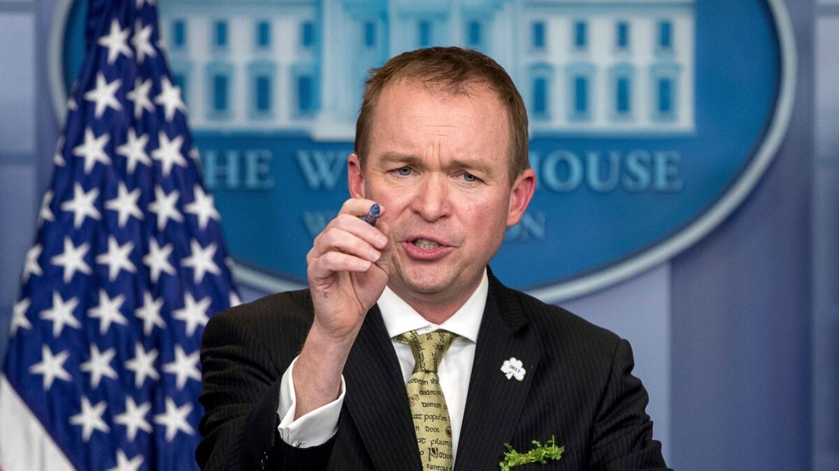 White House budget director Mick Mulvaney, shown speaking at the White House last month, says that Democratic negotiators on a spending bill need to agree to funding President Trump's top priorities, such as a border wall and additional immigration agents.