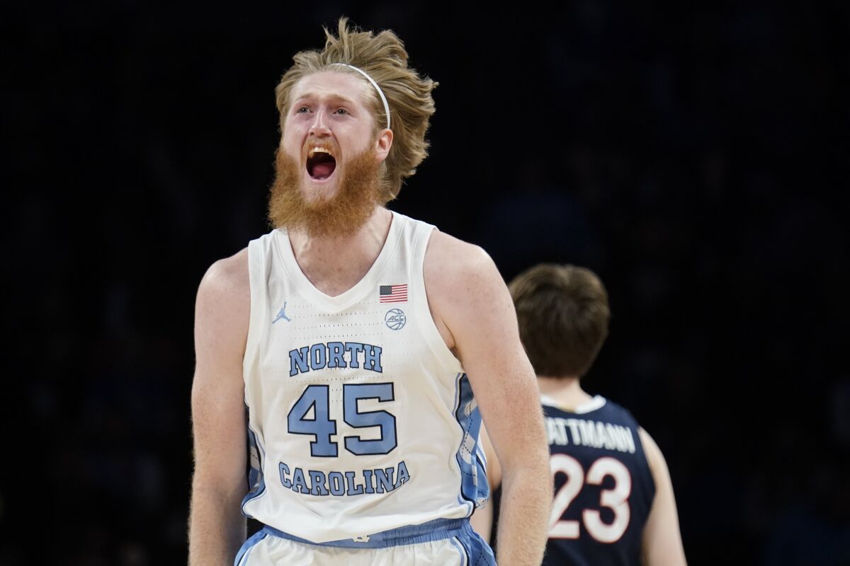 North Carolina's Brady Manek (45) celebrates after scoring three points in the first half of an NCAA college basketball game against Virginia during quarterfinals of the Atlantic Coast Conference men's tournament, Thursday, March 10, 2022, in New York. (AP Photo/John Minchillo)
