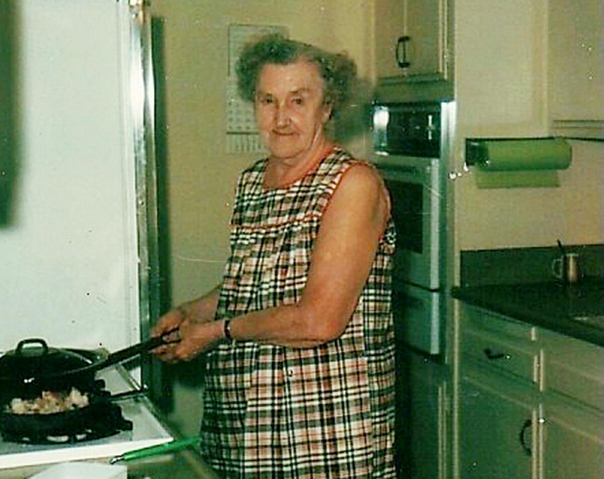 A woman at a stove.