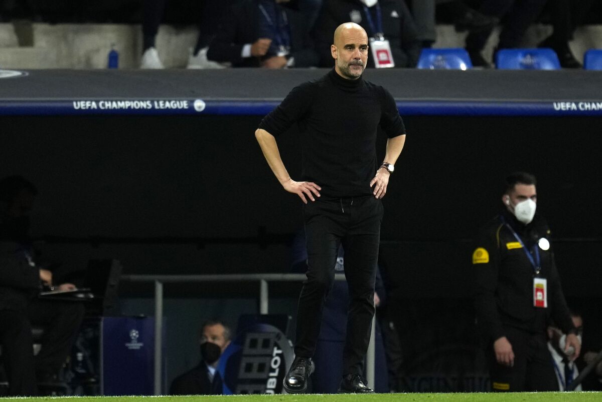 Manchester City's head coach Pep Guardiola reacts during the Champions League semi final, second leg soccer match between Real Madrid and Manchester City at the Santiago Bernabeu stadium in Madrid, Spain, Wednesday, May 4, 2022. (AP Photo/Manu Fernandez)