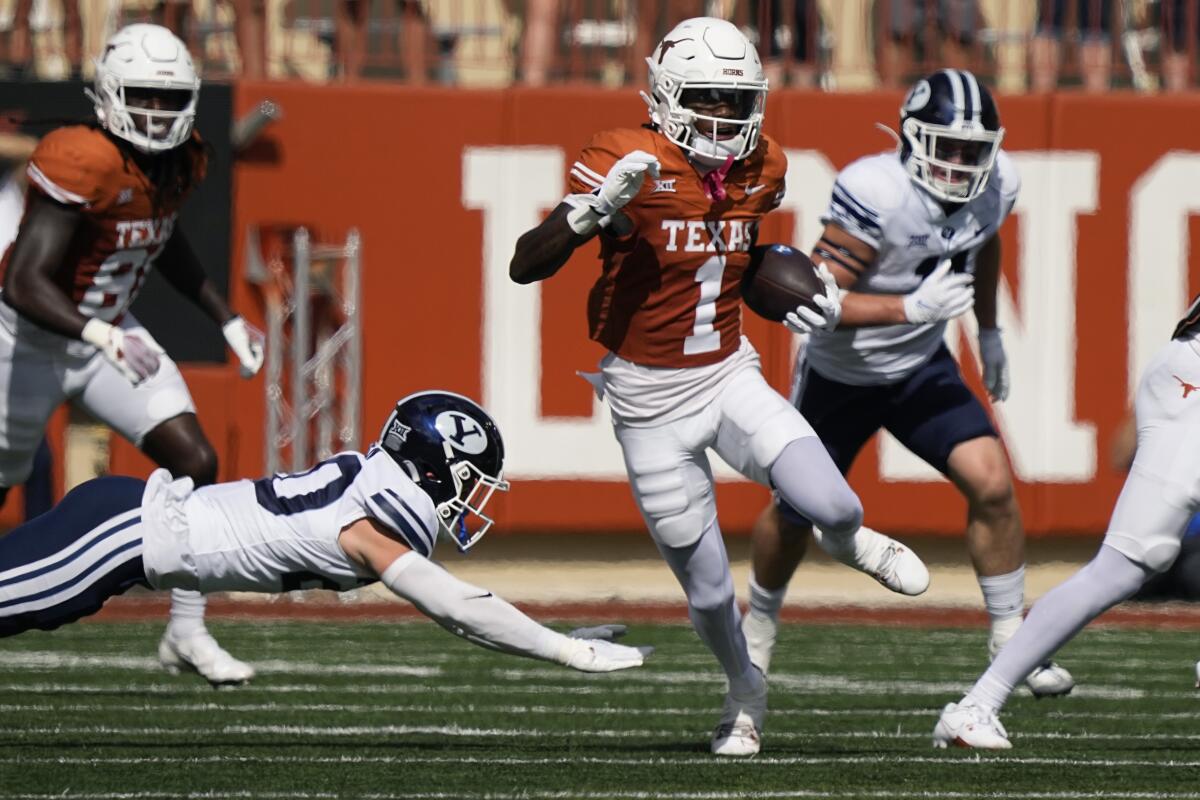 Texas' Xavier Worthy (1) returns a punt for a touchdown against BYU.