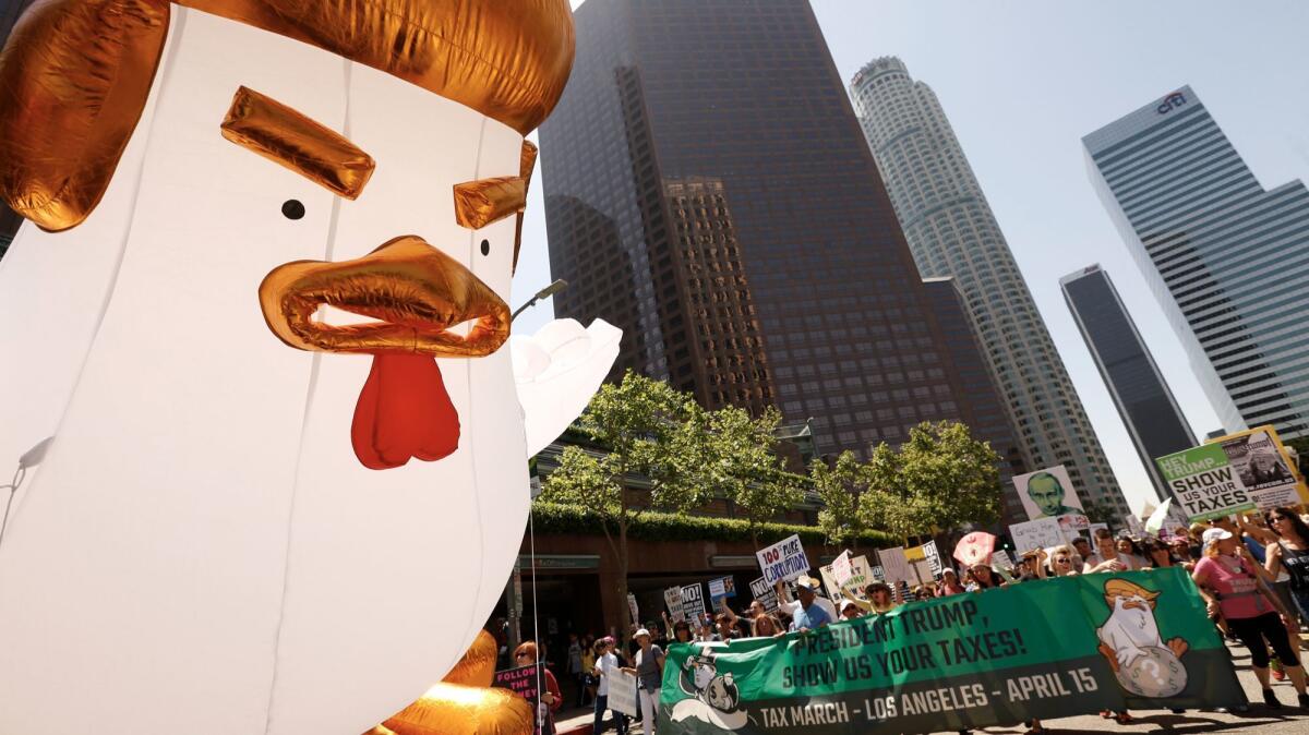 Protesters in downtown Los Angeles march and demand President Trump release his tax returns.
