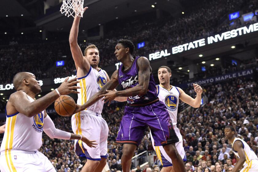 Toronto's Louis Williams passes the ball while Golden State's Marreese Speights, left, David Lee, middle, and Klay Thompson defend during the Warriors' 113-89 victory over the Raptors.