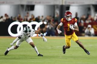 USC running back Eli Sanders runs with the ball during a win over Michigan State on Saturday night.