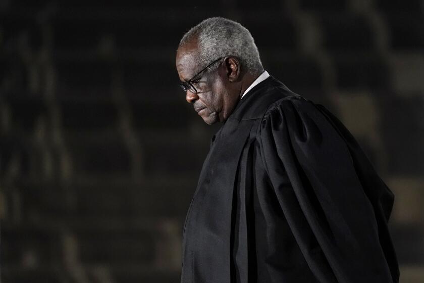 Supreme Court Justice Clarence Thomas listens as President Donald Trump speaks before administering the Constitutional Oath to Amy Coney Barrett on the South Lawn of the White House in Washington, Monday, Oct. 26, 2020, after she was confirmed by the Senate earlier in the evening. (AP Photo/Patrick Semansky)
