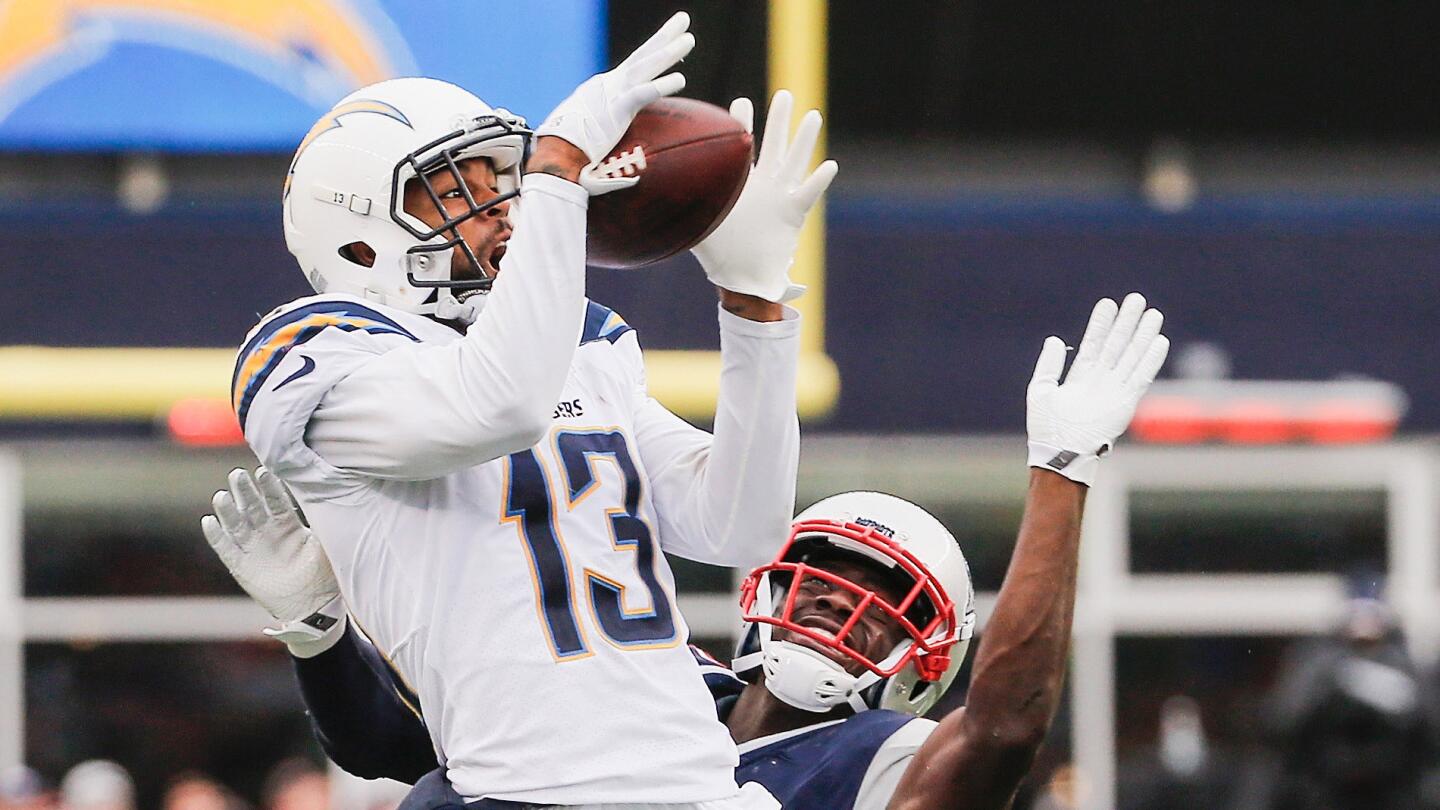 The Chargers' Keenan Allen catches a pass as he is defended by the Patriots' Johnson Bademosi during the third quarter.